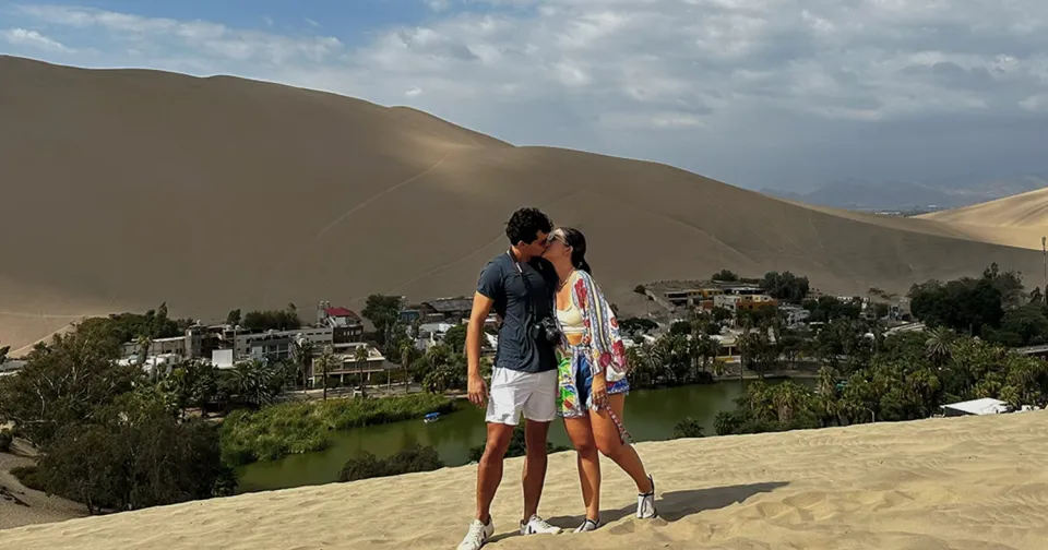 Couple overlooking Huacachina Oasis in Peru Couple overlooking Huacachina Oasis in Peru